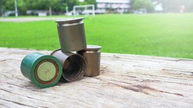 Used copper empty bullet shells on wood plank