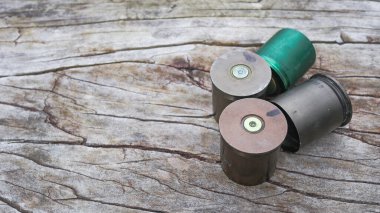 Used copper empty bullet shells on wood plank