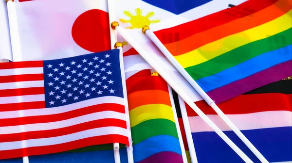 LGBT rainbow flag stay together with the flag of countries background to enhance LGBTQ+ community around the world