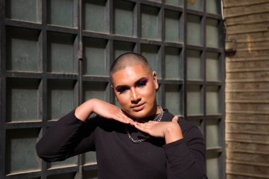 İkili olmayan, Güney Amerika kökenli ve genç bir kişi, makyaj sanatçısı ve Avrupa 'da seyahat ederken fotoğraflar için poz veriyor. Eşitlik kavramı, homoseksüellik, gey, lezbiyen, transseksüel, gey gururu.