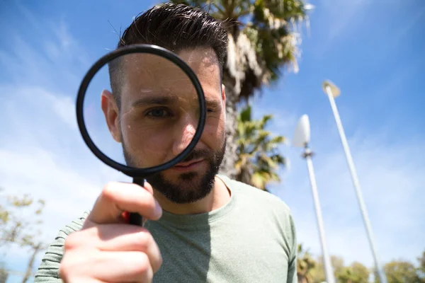 Handsome Young Man Looks Magnifying Glass His Magnified Eye Can — Stock Photo, Image