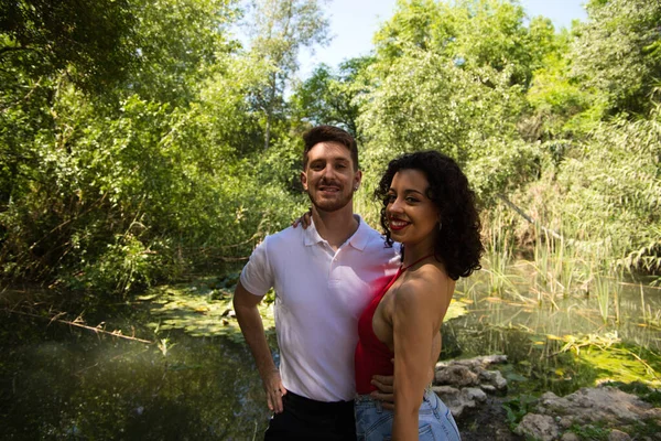 Young couple of Latin dancers, handsome and in love are walking in the park while showing their love. Woman and man are happy, in love and love each other. Love concept.