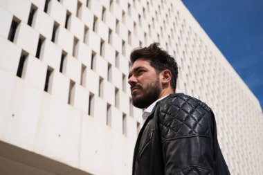 Sakallı, heykel gibi vücudu olan yakışıklı genç bir adam. Ofis müdürü olarak çalıştığı binaya gelmeden önce parkta yürüyordu. Çalışma ve yönetim kavramı.