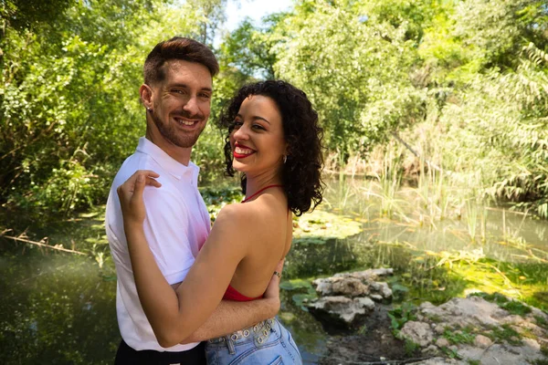 Young couple of Latin dancers, handsome and in love are walking in the park while showing their love. Woman and man are happy, in love and love each other. Love concept.