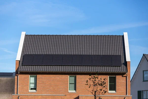 Solar panels installed on the tiled roof of a new house