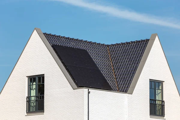 Solar panels installed on the tiled roof of a new house