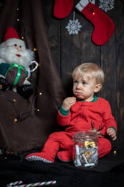 Noel kurabiyesi yiyen tatlı, sarışın bebek. Bebeğin ilk Noel 'i.