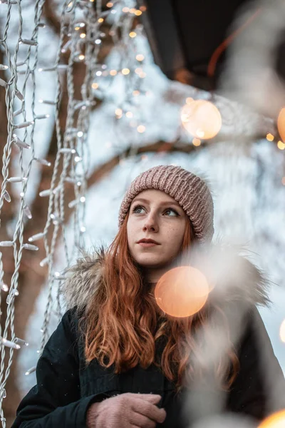Beautiful girl surrounded with christmas lights. Christmas time is here.