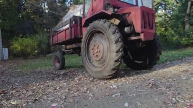 Ormandaki çiftçi evinin yanındaki eski kırmızı traktör.
