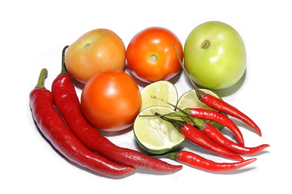 Fresh tomatoes, red hot chillies and lime cut isolated in white background — Stock Photo, Image