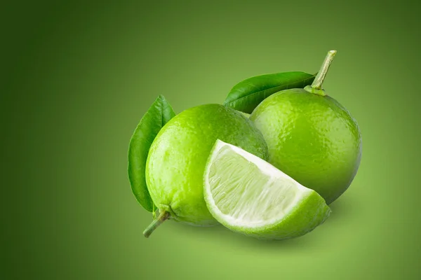 Whole Sliced Limes Sour Green Fruit Isolated Green Background — стоковое фото