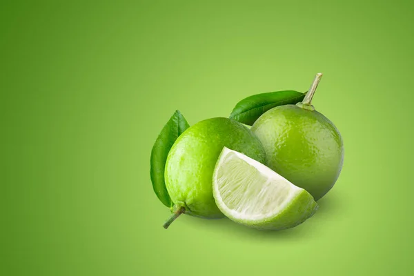 Whole Sliced Limes Sour Green Fruit Isolated Green Background — стоковое фото