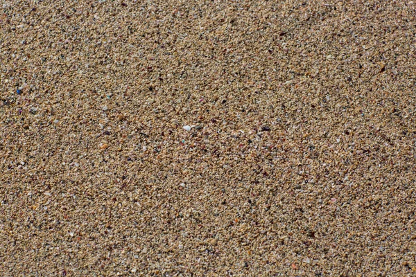 ビーチの砂の質感 砂の背景の美しい 茶色の砂浜 トップビューの抽象的な背景 海の砂の領域の完全なフレームショットを閉じます 小石の質感 — ストック写真