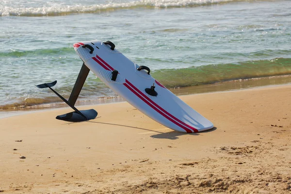 Kite surfing on the sand in the background of beautiful sea. Kiteboarding, surfboard, water sport. Healthy Active Lifestyle. Surfing. Summer Vacation. Extreme Sport. Copy space for your text, close up