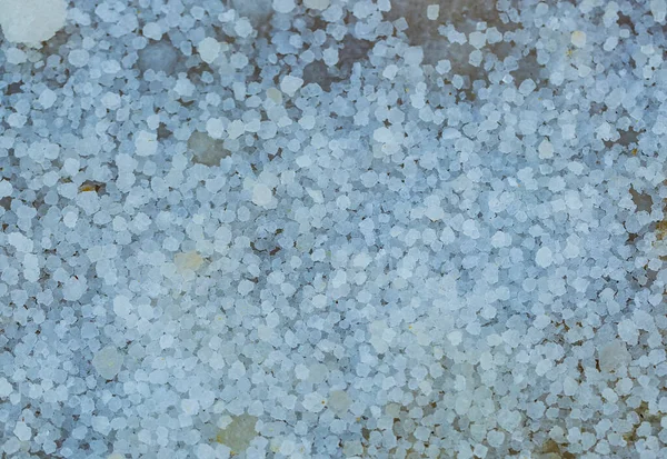Salts crystals, close up. Selective focus with shallow depth of field. Background made of salt from the Dead Sea, large round cubes. Macro of white crystals of rock sea salt. Crystallised Sea-salt