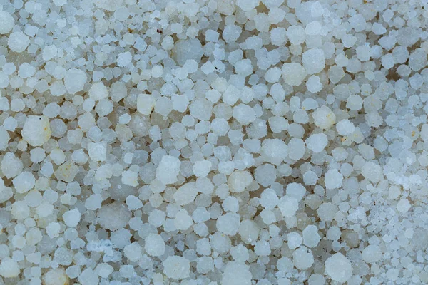 Background of salt from the Dead Sea, round cubes. Salts crystals, close up. Selective focus, shallow depth of field. Macro of white crystals, rock sea salt. Crystallised Sea-salt, Ein Bokek beach