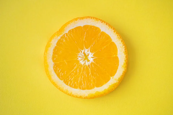 stock image fresh orange slices on a yellow background.
