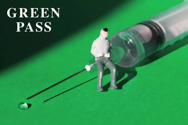Miniature Man Siting Syringe Needle Green Background — Stock Photo, Image