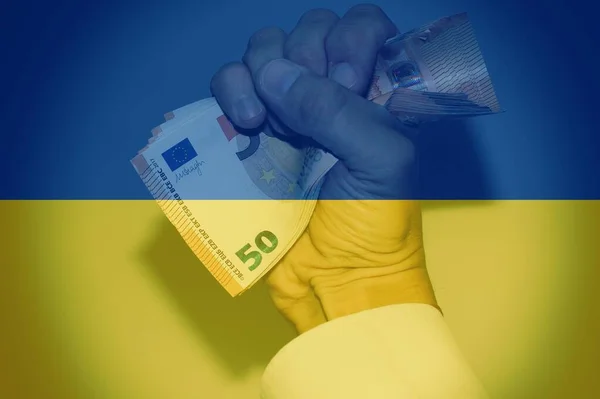 Hand Holding European Banknotes Ukrainian Flag Background Concept Financial Help — стокове фото