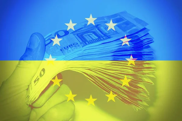 Hand Holding European Banknotes Ukrainian Flag Background Concept Financial Help — стокове фото