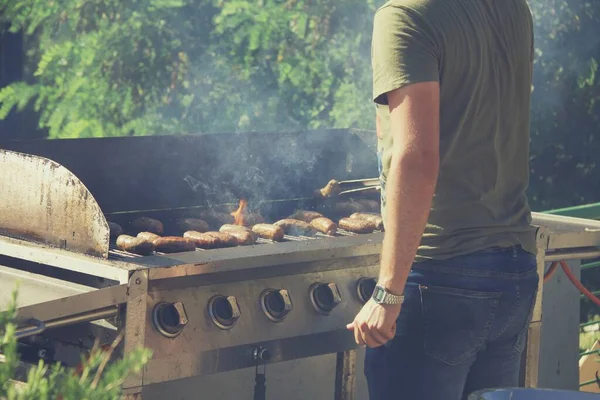 Guy Cooking Sausages Barbecue Grill Open Fire Summer Day Backyard — Photo