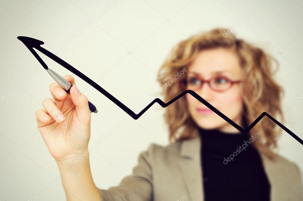 businesswoman drawing graph with pen