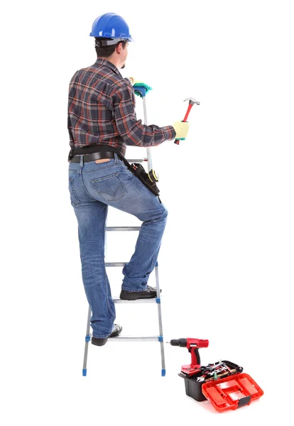 Carpenter with hammer on the stepladder — Stock Photo, Image