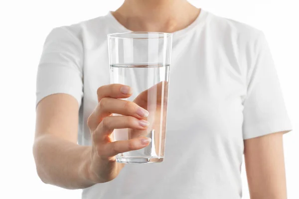 Beyaz arka planda elinde temiz bir bardak Watter tutan kadının yakın plan görüntüsü.