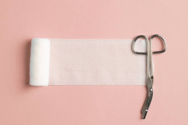 Close up view of single bandage and specialistic scissors on 