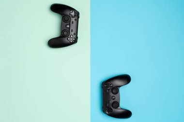 Two modern, wireless game pad competing in a computer game. The concept of playing games