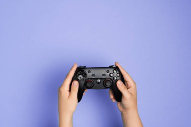 Woman plays video games with the console. Hands with 
