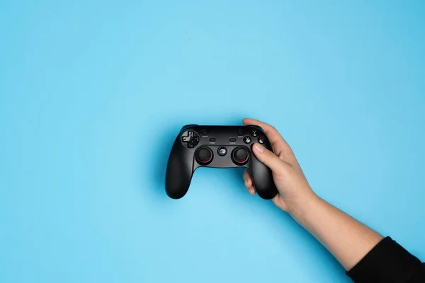 Woman plays video games with the console. Hands with