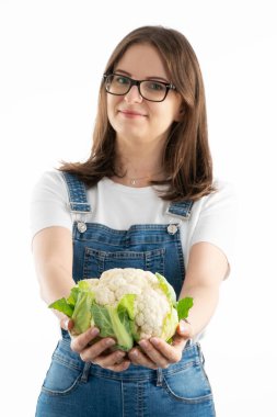 Young happy woman with fresh cauliflower. Choosing a healthy diet and life style.