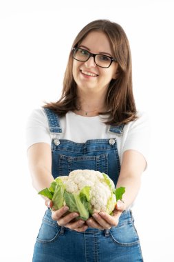 Young happy woman with fresh cauliflower. Choosing a healthy diet and life style.