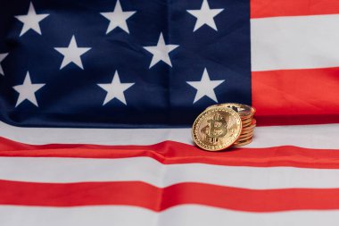 Crypto currency bitcoin coins on an United States flag.