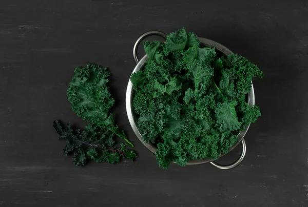 Frisch grüne Grünkohlblätter, in einem Metallsieb auf grauem Hintergrund, Draufsicht, waagerecht, keine Menschen, — Stockfoto