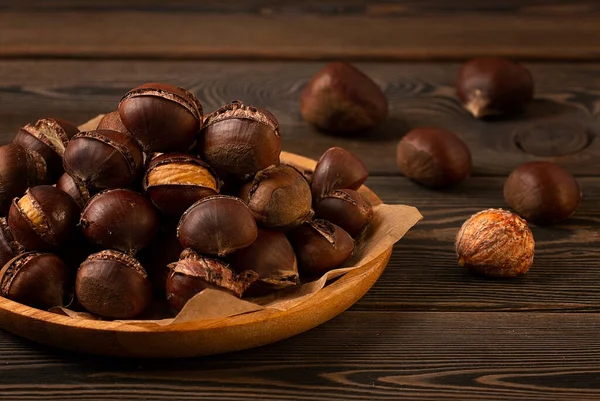 Roasted chestnut, on a wooden table, no people, — Stockfoto