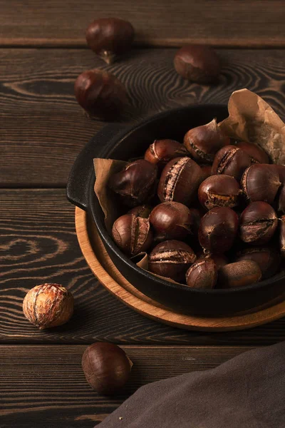 Roasted chestnut, on a wooden table, no people, — Foto Stock
