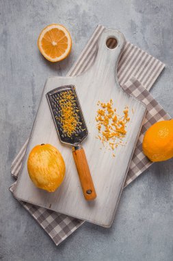 Grated lemon zest, on a cutting board, with a grater , top view, no people,