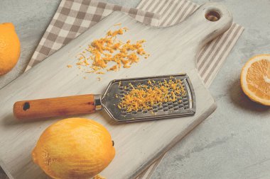 Grated lemon zest, on a cutting board, with a grater , top view, no people,