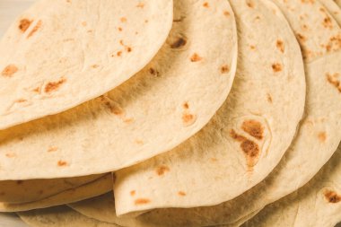 A stack of Mexican tortillas, on a gray table, top view, close-up, no people,