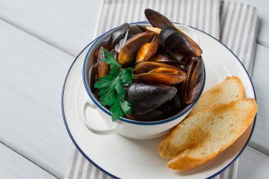 Fresh, Boiled mussels, Black Sea, with white bread, on a white wooden table, no people,