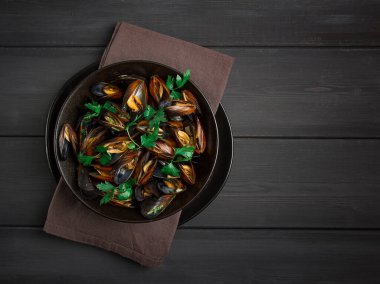 Fresh, Boiled mussels, Black Sea, with parsley and lemon, on a wooden table, no people,