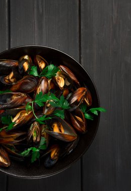 Fresh, Boiled mussels, Black Sea, with parsley and lemon, on a wooden table, no people,