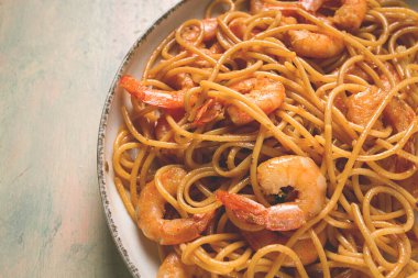 Spaghetti with king shrimps , with spices, top view, selective focus, homemade, no people,