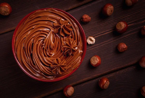Chocolate nut paste, mousse, pasta, in a cup, on a wooden table, top view, selective focus, no people,