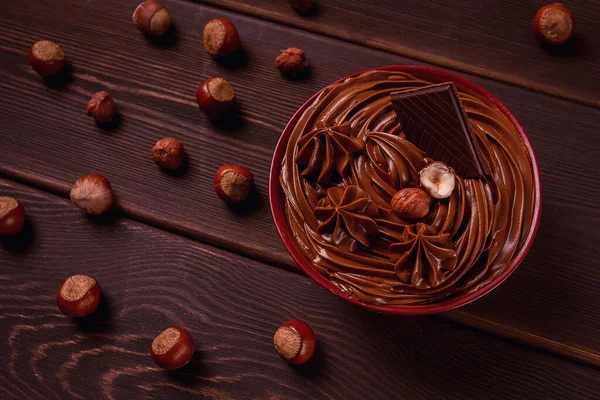 Chocolate nut paste, mousse, pasta, in a cup, on a wooden table, top view, selective focus, no people,