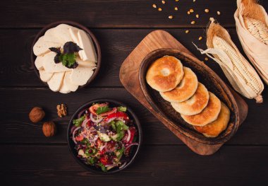 Mchadi, corn tortillas, traditional Georgian dish, corn bread, with Imeretian cheese, homemade, no people, on a wooden table,