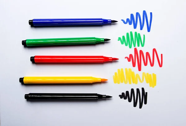 Watercolor pens brush, assortment, on a drawing album, artist's desk, top view, close-up, selective focus,