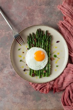 ızgara kuşkonmaz, kızarmış yumurta, baharat ve otlar, parmesan peyniri, bej bir tabakta, üst manzara, kırsal, insan yok.